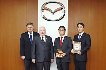 From Left: Piotr Gulczynski, President of the Board of Executives, Lech Walesa Institute; Lech Walesa; Mazda's Vice Chairman of the Board, Seita Kanai, and President and CEO, Masamichi Kogai