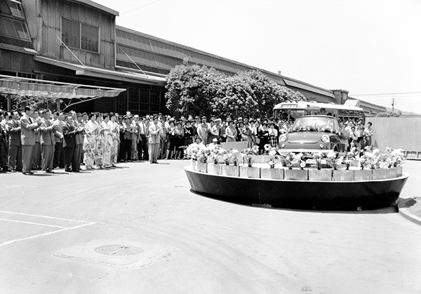 Introduction ceremony in front of statue at headquarters