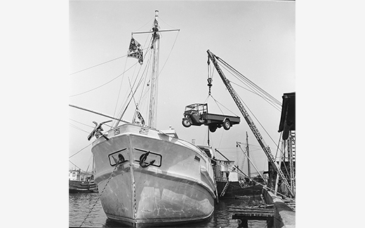 Three-wheeled Truck being loaded on a ship (1954)